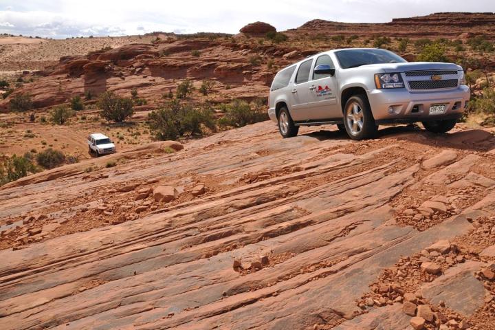 a car parked on the side of a dirt road
